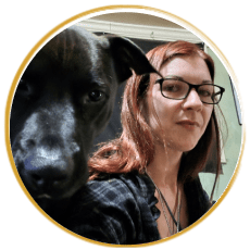 female with glasses and large black dog